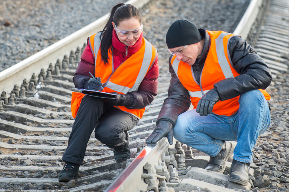 Photo of two people inspecting a railway line