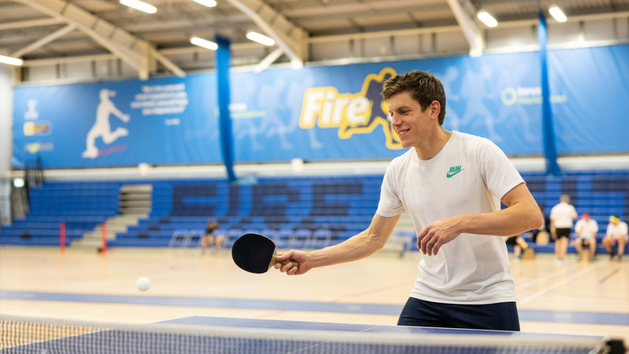 Photo of someone playing table tennis in a sports hall