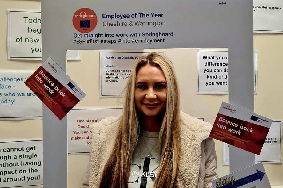 Photo of a person stood in an oversized photo frame
